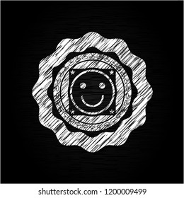 happy face icon inside chalkboard emblem