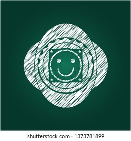 happy face icon inside chalkboard emblem on black board