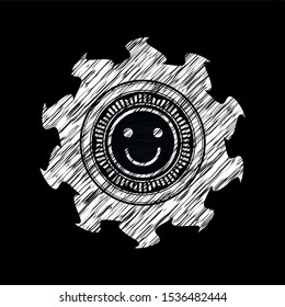 happy face icon inside chalkboard emblem written on a blackboard