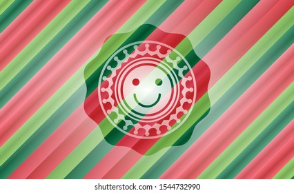 happy face icon inside christmas badge.