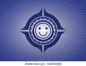 happy face icon inside denim background