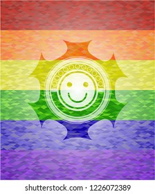 happy face icon inside emblem on mosaic background with the colors of the LGBT flag