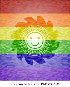 happy face icon inside emblem on mosaic background with the colors of the LGBT flag