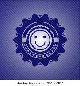 happy face icon inside emblem with jean background