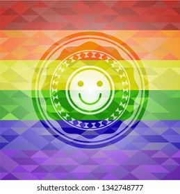 happy face icon inside emblem on mosaic background with the colors of the LGBT flag