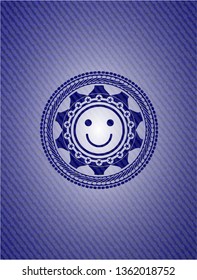 happy face icon inside emblem with denim texture