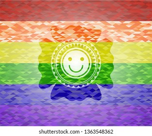 happy face icon inside emblem on mosaic background with the colors of the LGBT flag