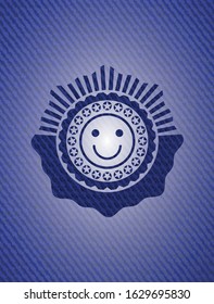 happy face icon inside emblem with denim texture