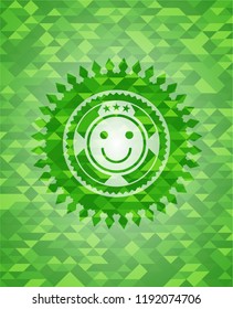 happy face icon inside green emblem with mosaic background