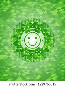 happy face icon inside green mosaic emblem