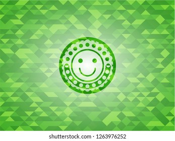 happy face icon inside green emblem. Mosaic background