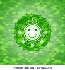 happy face icon inside green emblem with mosaic ecological style background