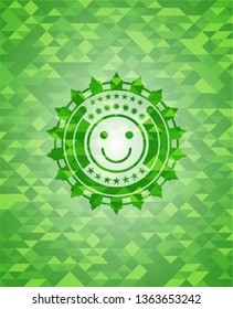 happy face icon inside green emblem. Mosaic background