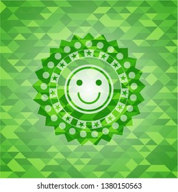 happy face icon inside green emblem. Mosaic background