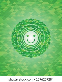 happy face icon inside green emblem. Mosaic background