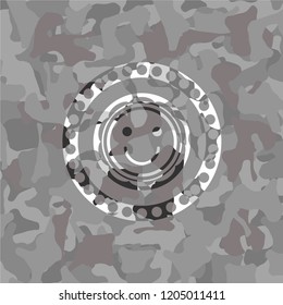 happy face icon inside grey camo texture
