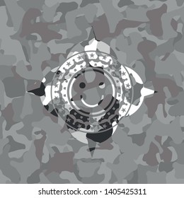 happy face icon inside grey camouflage texture