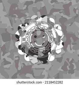 happy face icon inside grey camo texture. 