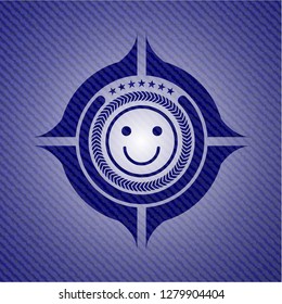 happy face icon inside jean or denim emblem or badge background