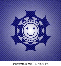 happy face icon inside jean or denim emblem or badge background