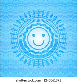 happy face icon inside light blue water style emblem.