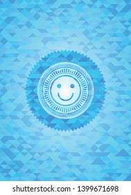 happy face icon inside light blue mosaic emblem