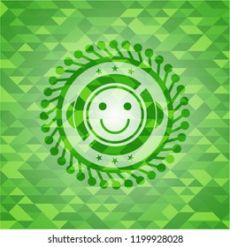 happy face icon inside realistic green mosaic emblem