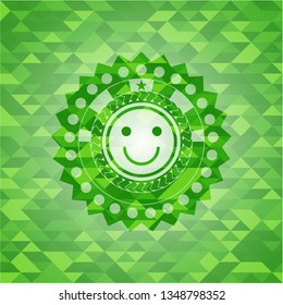 happy face icon inside realistic green mosaic emblem