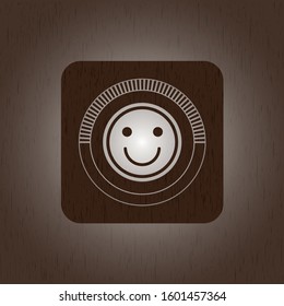 happy face icon inside realistic wooden emblem