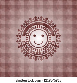 happy face icon inside red seamless geometric badge.