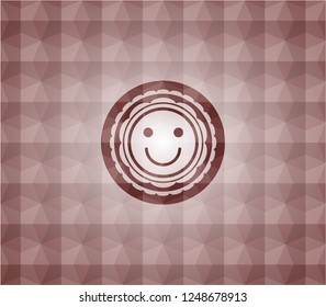 happy face icon inside red emblem with geometric pattern background. 