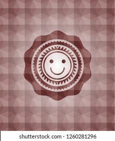 happy face icon inside red seamless geometric emblem.