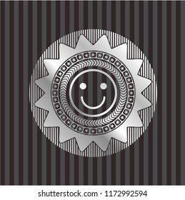 happy face icon inside silver emblem