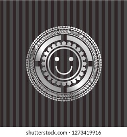 happy face icon inside silver shiny emblem