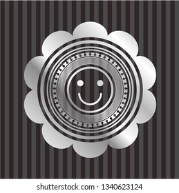 happy face icon inside silver badge or emblem
