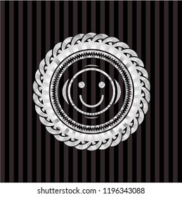 happy face icon inside silvery badge