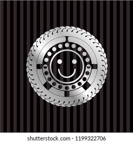 happy face icon inside silvery emblem