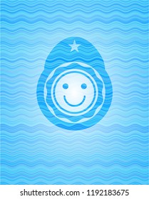 happy face icon inside sky blue water wave emblem.