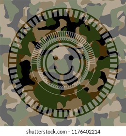 happy face icon on camo texture