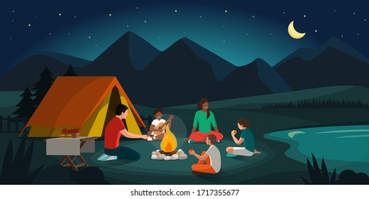 Happy Family Camping In The Forest At Night: They Are Sitting Around A Fire, Eating And Having Fun