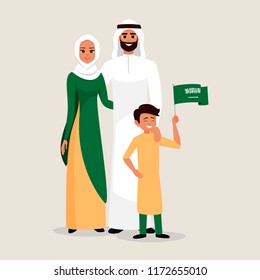 Happy family celebrating the Independence Day of Saudi Arabia. Smiling Father, mother and son holding the flag of Saudi Arabia.