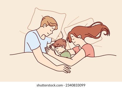 Happy family couple with child sleeps in bed and smiles enjoying healthy sleep and restoring strength after hard day work. Family of man and woman hugging sleeping son lying under blanket