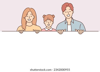 Happy family displays large white banner and smiles offering to take advantage of promotional recommendation. Happy parents and daughter with blank billboard for applying marketing offer or logo