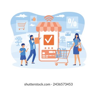 Happy family doing grocery shopping online with a mobile app on their smartphone, the woman is holding a shopping cart with products and the woman is making the payment with a credit card. 