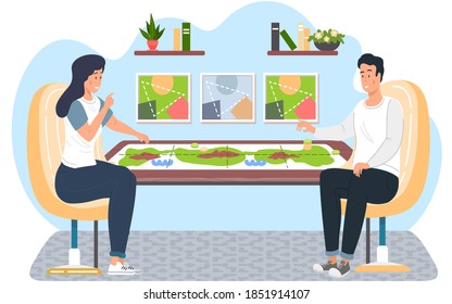 Happy family or friends man and woman sitting at a table and playing strategy logical board game, spending time together at home. Family fun activity. Indoor entertainment for adults and children