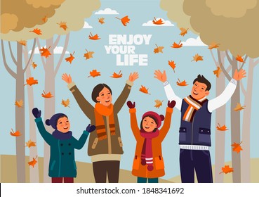 Happy family having fun and playing with autumn leaves in park. Autumn landscape background