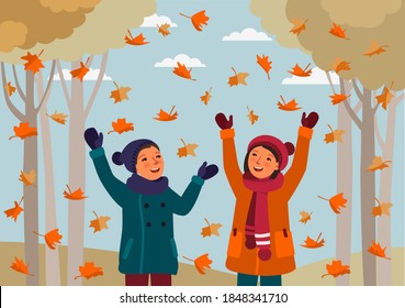 Happy family having fun and playing with autumn leaves in park. Autumn landscape background