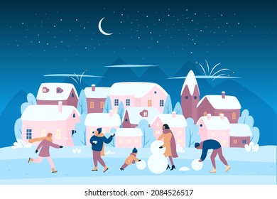 Happy family making snowman at Christmas evening and night vector illustration. Cartoon people playing snowballs on city street with houses and trees under snow, winter fun activity outdoor background