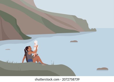 A Happy Family Sits On The Beach. Mom And Dad Play With The Baby. Beautiful Views Of The Mountains Among The Sea. Day Of Family, Love And Fidelity