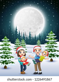 Happy family in the snowy garden at night